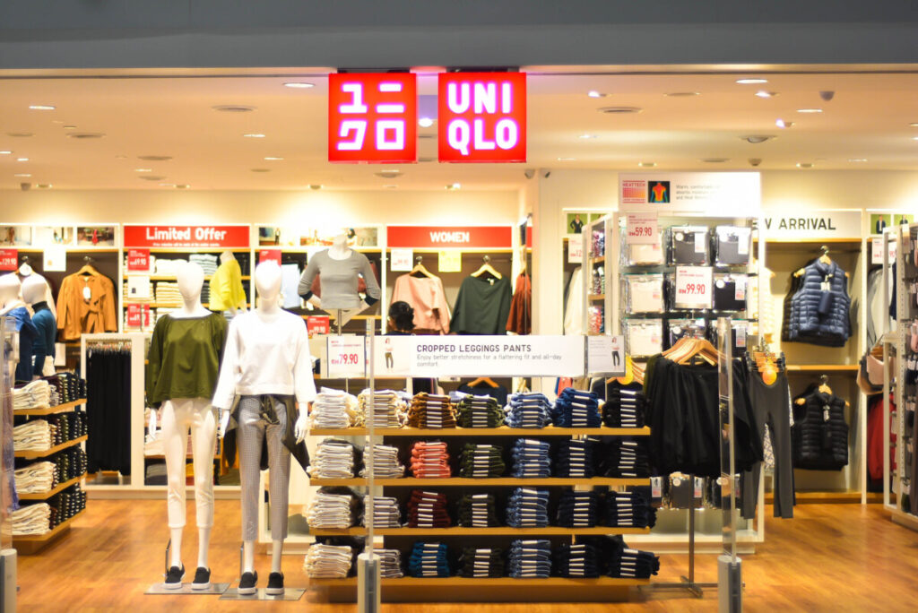 Uniqlo store in Japan with tax-free shopping for tourists featuring clothing displays and red brand signage